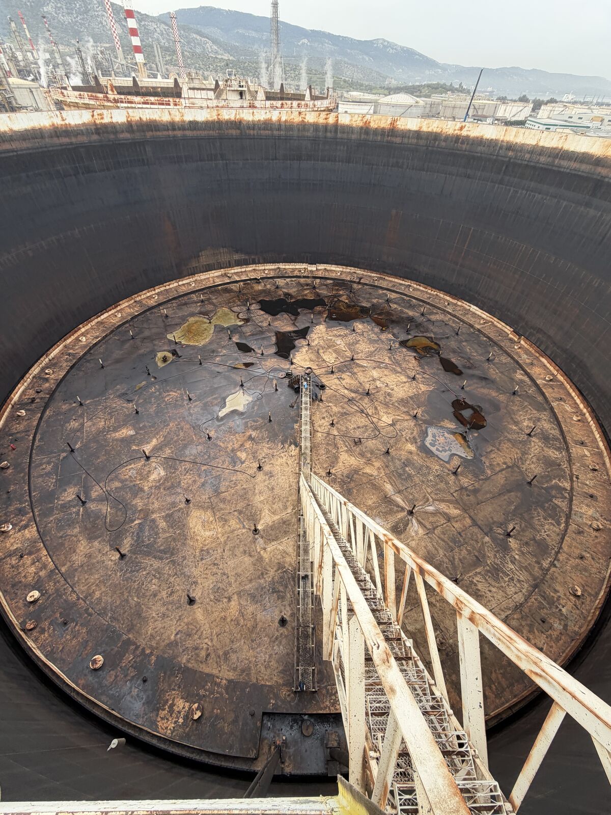 Top-down view of a tank floor with access ramp during cleaning