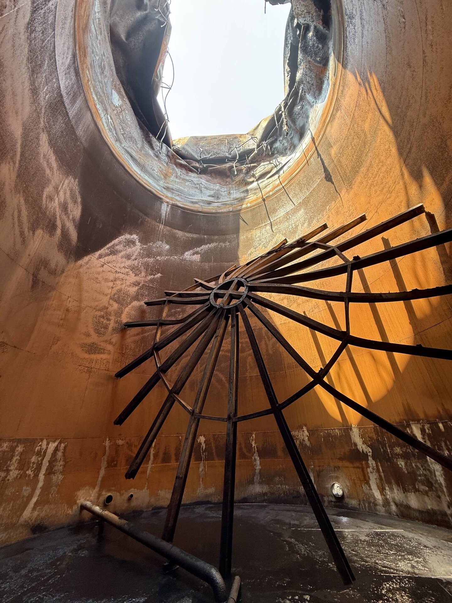 Operator performing high-pressure hydro-blasting on industrial pipework